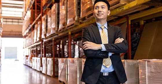 Image of business owner standing in warehouse